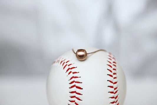 Wear this Baseball Pendant on game day and everyday! Product Details 14k Rose gold, 18" rose gold cable chain Note: this product contains only 14k rose gold. Lobster clasp Pendant: 9mm, baseball is 3D Necklace box included