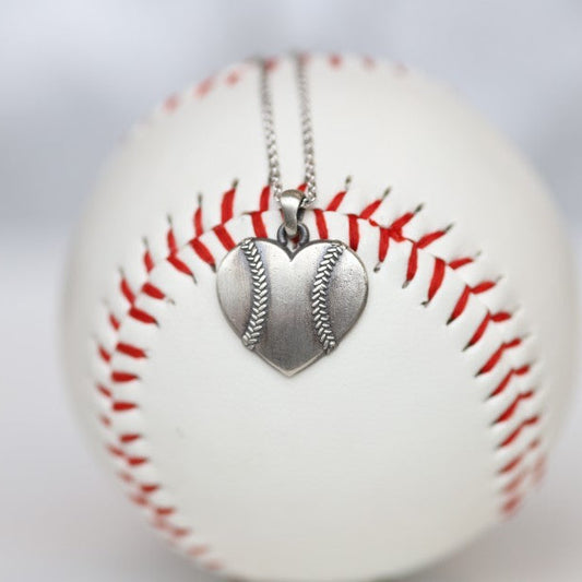 Baseball Heart Pendant in Sterling Silver Show your love of baseball with our Baseball Heart Pendant! Product Details Sterling silver Sterling silver cable chain Lobster clasp Pendant: 22mm Necklace box included