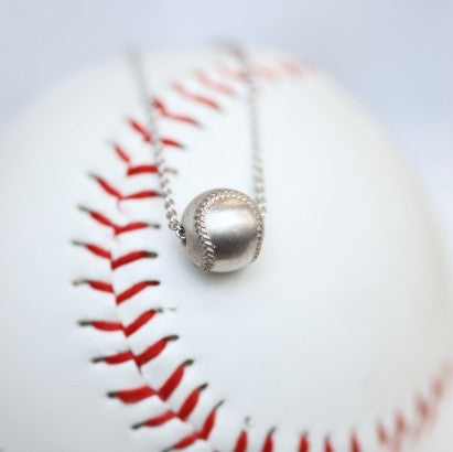 Wear this Baseball Pendant on game day and everyday! Product Details Sterling silver 18" sterling silver cable chain Lobster clasp Pendant: 9mm, baseball is 3D Necklace box included
