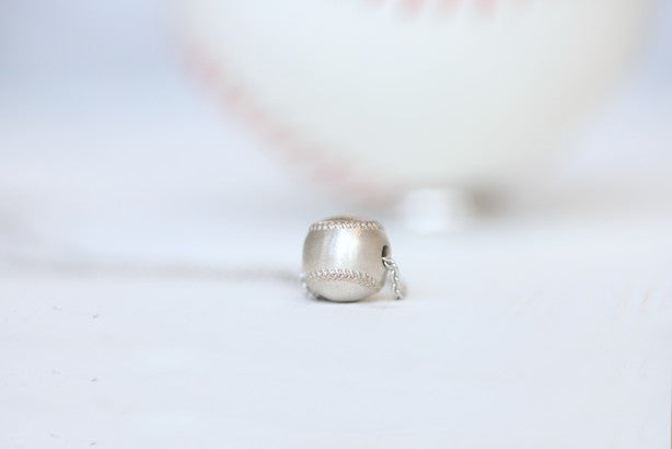 Wear this Baseball Pendant on game day and everyday!  Product Details  Sterling silver 18" sterling silver cable chain Lobster clasp Pendant: 9mm, baseball is 3D Necklace box included  