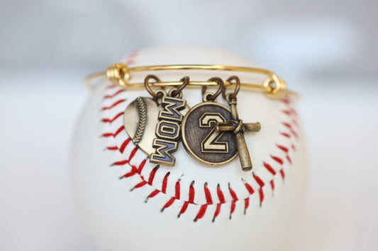 Create your own personalized charm bracelet!   This bracelet comes with the Baseball Heart Charm, please select any other charms that you would like to add to your bracelet!  If you would like to add a Jersey Number Charm: please select the number range you would like to order. There will be a place during Check Out to add this information in the "Note to Seller" box.   Product Details  Bracelet is one size fits all Color: yellow Charms: bronze Gift Custom