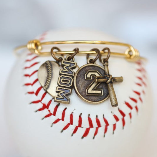 Create your own personalized charm bracelet! This bracelet comes with the Baseball Heart Charm, please select any other charms that you would like to add to your bracelet! If you would like to add a Jersey Number Charm: please select the number range you would like to order. There will be a place during Check Out to add this information in the "Note to Seller" box. Product Details Bracelet is one size fits all Color: yellow Charms: bronze Gift Custom