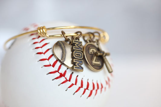 Create your own personalized charm bracelet! This bracelet comes with the Baseball Heart Charm, please select any other charms that you would like to add to your bracelet! If you would like to add a Jersey Number Charm: please select the number range you would like to order. There will be a place during Check Out to add this information in the "Note to Seller" box. Product Details Bracelet is one size fits all Color: yellow Charms: bronze