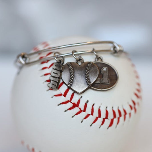 Create your own personalized charm bracelet! This bracelet comes with the Baseball Heart Charm, please select any other charms that you would like to add to your bracelet! If you would like to add a Jersey Number Charm: please select the number range you would like to order. There will be a place during Check Out to add this information in the "Note to Seller" box. Product Details Bracelet is one size fits all Color: white Charms: white bronze