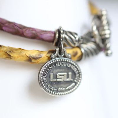 Perfect for any season! Each Mother of Pearl is one-of-a-kind. Features: Sterling silver Mother of pearl with purple enamel inlay Lobster clasp Pendant: 22x22mm LSU Louisiana State University Football Baseball Soccer Volleyball Track Graduate Grad Graduation Mom Dad Mother Father Wedding Gift Present Tigers Geaux Baton Rouge