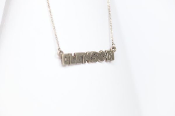 Celebrate the 2016 Clemson Tigers Football National Championship victory! Features: Sterling silver Purple and yellow enamel Lobster clasp Officially licensed product Pendant box included