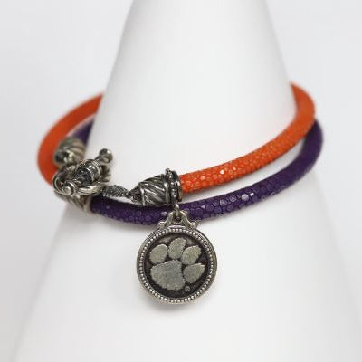 Finish off your Clemson game day look with our purple and orange stingray leather charm bracelet. Features: Sterling silver Toggle clasp Stingray leather Double sided charm Officially licensed product