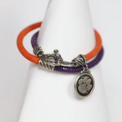 Finish off your Clemson game day look with our purple and orange stingray leather charm bracelet. Features: Sterling silver Toggle clasp Stingray leather Double sided charm Officially licensed product