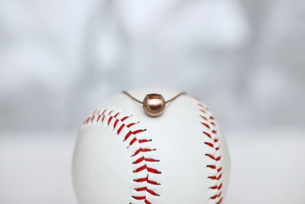 Wear this Baseball Pendant on game day and everyday!  Product Details  14k Rose gold,  18" rose gold cable chain Note: this product contains only 14k rose gold. Lobster clasp Pendant: 9mm, baseball is 3D Necklace box included