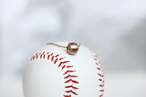 Wear this Baseball Pendant on game day and everyday!  Product Details  14k Rose gold,  18" rose gold cable chain Note: this product contains only 14k rose gold. Lobster clasp Pendant: 9mm, baseball is 3D Necklace box included