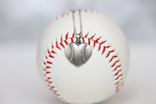 Baseball Heart Pendant in Sterling Silver Show your love of baseball with our Baseball Heart Pendant!  Product Details  Sterling silver Sterling silver cable chain Lobster clasp Pendant: 22mm﻿ Necklace box included