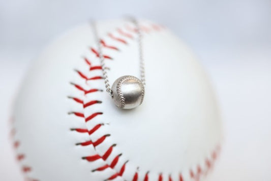 Wear this Baseball Pendant on game day and everyday!  Product Details  Sterling silver 18" sterling silver cable chain Lobster clasp Pendant: 9mm, baseball is 3D Necklace box included  
