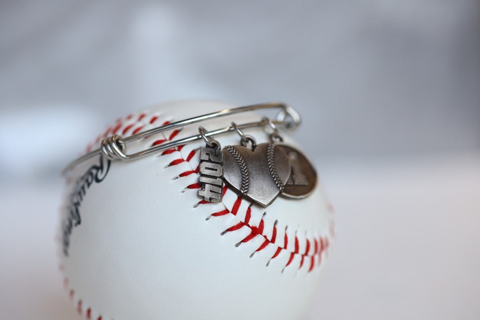 Create your own personalized charm bracelet!   This bracelet comes with the Baseball Heart Charm, please select any other charms that you would like to add to your bracelet!  If you would like to add a Jersey Number Charm: please select the number range you would like to order. There will be a place during Check Out to add this information in the "Note to Seller" box.   Product Details  Bracelet is one size fits all Color: white Charms: white bronze
