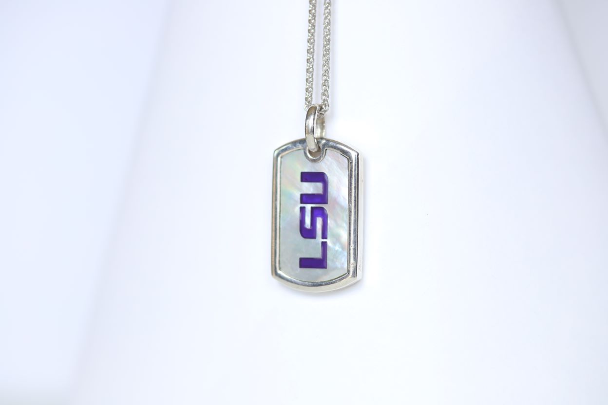 This piece is perfect for men or women! Each Mother of Pearl is one-of-a-kind. Features: Sterling silver Mother of pearl with purple enamel inlay Lobster clasp Pendant: 29x17mm