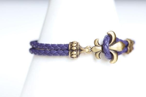Finish off your LSU game day look with our purple and jewelry bracelet gold leather charm bracelet.   Features:  Sterling silver Toggle clasp Stingray leather  Double sided charm Officially licensed product football baseball soccer volleyball cheer mom dad father wedding gift present men women Louisiana State university purple gold yellow tigers leather lsu lsu lsu  
