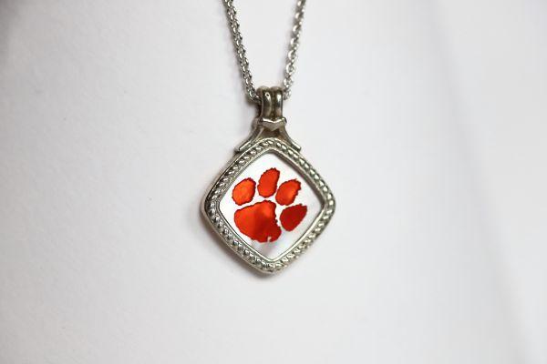Made for the biggest Clemson fan! This is a one-of-a-kind piece.   Features:  Amethyst accents Man made opal center 14k gold Cable chain with lobster clasp 18" chain Officially licensed product  Pendant box included