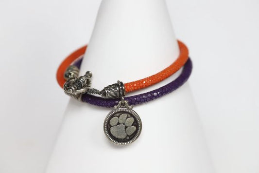Finish off your Clemson game day look with our purple and orange stingray leather charm bracelet.   Features:  Sterling silver Toggle clasp Stingray leather  Double sided charm Officially licensed product